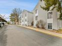 Street view of condos featuring light gray siding, neat landscaping, and convenient carport parking at 3432 S Locust St # A, Denver, CO 80222