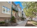 Stylish townhouse showcasing a balcony, red door, and well-kept landscaping in a desirable neighborhood at 880 E 16Th Ave # D, Denver, CO 80218