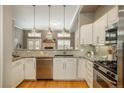 Modern kitchen featuring stainless steel appliances, a kitchen bar, and a gas range with oven at 880 E 16Th Ave # D, Denver, CO 80218