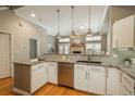 Bright kitchen featuring stainless appliances, granite countertops, and an open layout to the living room at 880 E 16Th Ave # D, Denver, CO 80218