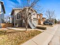 Two-story house with a front yard, driveway and white stairs leading to a red door entrance at 3155 Kedleston Ave, Highlands Ranch, CO 80126