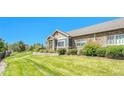 Beautifully landscaped front yard featuring healthy green grass, mature trees, and tasteful landscaping at 12444 Madison Way, Thornton, CO 80241