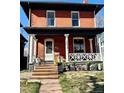 Charming two-story brick home with a covered front porch, lovely landscaping, and welcoming curb appeal at 2631 W 34Th Ave, Denver, CO 80211