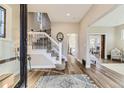 Welcoming foyer with hardwood floors, elegant staircase, and charming entryway features at 2631 W 34Th Ave, Denver, CO 80211