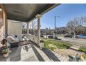 Relaxing front porch features cozy seating and a charming view of the neighborhood street at 2631 W 34Th Ave, Denver, CO 80211