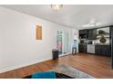Wood floors flow throughout the home and into the kitchen area with stainless steel appliances at 8820 Poze Blvd, Thornton, CO 80229