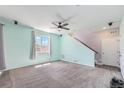 Spacious living room with carpet and stairs at 10506 Akron St, Commerce City, CO 80640
