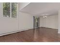A bright living room with wood flooring, a large window and sliding glass door, ready for personalized touches at 6455 E Bates Ave # 4-105, Denver, CO 80222