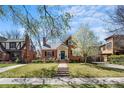 Charming brick home with well-maintained lawn, blooming tree, and welcoming front porch offering classic curb appeal at 1615 Kearney St, Denver, CO 80220