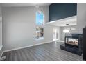 Bright living room with fireplace, gray flooring and large window at 4575 Gibraltar St, Denver, CO 80249