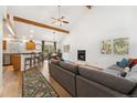 Spacious open-concept living room with hardwood floors, vaulted ceilings and a cozy fireplace at 34103 Forest Park Dr, Elizabeth, CO 80107