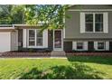 Charming home exterior featuring a brick facade, well-maintained lawn, and beautiful white shutters at 9575 Garland Ct, Westminster, CO 80021