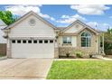 Charming single-Gathering home with stone accents, lush lawn, and attached two-car garage at 3612 Rosewalk Cir, Highlands Ranch, CO 80129