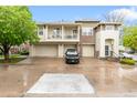 Exterior of a townhome with 3 car garage and a black car at 12973 Grant E Cir # A, Thornton, CO 80241