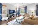 Cozy living room featuring hardwood floors, large windows and comfortable seating at 12973 Grant E Cir # A, Thornton, CO 80241