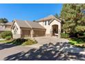 Elegant home exterior featuring a three-car garage, well-maintained landscaping, and a welcoming entrance at 3104 Ramshorn Dr, Castle Rock, CO 80108