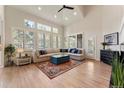 Bright living room with high ceilings, large windows, and hardwood floors at 3104 Ramshorn Dr, Castle Rock, CO 80108