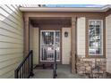 The front entry features a decorative security door, stone accents and covered entry at 9174 Lark Sparrow Pl, Highlands Ranch, CO 80126