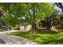 Traditional home with a large front yard and mature trees providing shade and curb appeal at 9174 Lark Sparrow Pl, Highlands Ranch, CO 80126