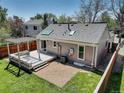 Aerial view of the backyard featuring a deck, pergola, gravel, a grassy area, and privacy fence at 291 W Sycamore Ln, Louisville, CO 80027