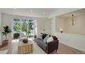 Cozy living room featuring a tufted sofa, large windows, and modern decor at 291 W Sycamore Ln, Louisville, CO 80027