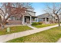View of a well-kept two-story home with an inviting front porch and green lawn at 11022 Newark St, Commerce City, CO 80640
