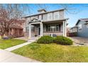 Attractive two-story house with a cozy front porch and lush green yard at 11022 Newark St, Commerce City, CO 80640