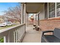 Inviting covered porch with white railings, perfect for relaxing outdoors at 11022 Newark St, Commerce City, CO 80640