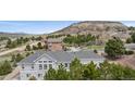 Elevated view of an upscale community, featuring well-maintained homes and landscaped yards, nestled among mature trees at 1553 Plowman Dr, Monument, CO 80132