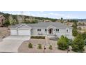 Charming home featuring a two-car garage and landscaped front yard, with a walkway leading to the front door at 1553 Plowman Dr, Monument, CO 80132