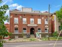 Attractive three-story red brick building with large windows, architectural details and convenient street access at 2524 Champa St # 1, Denver, CO 80205