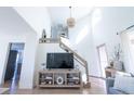 Bright entryway with hardwood floors, high ceilings, and a staircase with wood railing at 1431 Beacon Hill Dr, Highlands Ranch, CO 80126