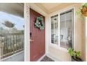 Inviting front door adorned with a wreath, natural light, and a glimpse of the interior at 9944 E Carolina Cir # 201, Aurora, CO 80247