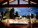 Contemporary fireplace with mountain scape glass, providing warmth and ambiance to the outdoor space at 12665 S Robinson Ranch Ct, Parker, CO 80134