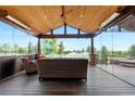 Relaxing sunroom featuring wood ceilings, comfortable seating, and expansive views of the outdoor scenery at 12665 S Robinson Ranch Ct, Parker, CO 80134