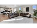 Bright living room features hardwood floors, with open concept view of kitchen island at 5271 Routt Ct, Arvada, CO 80002
