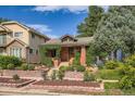 Quaint home with brick facade, garden beds, and manicured landscaping in a residential neighborhood at 827 S Sherman St, Denver, CO 80209