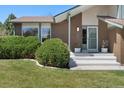 Charming home with a well-maintained front yard, garden, and inviting entryway at 7391 S Marion St, Centennial, CO 80122