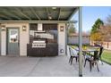 Outdoor kitchen with built-in grill and dining area, perfect for entertaining at 7391 S Marion St, Centennial, CO 80122