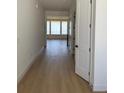 Bright hallway with hardwood floors leading to a room with large windows, filled with natural light at 901 Coal Bank Trl, Castle Rock, CO 80104