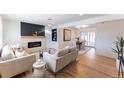 Bright living room with modern fireplace, hardwood floors and neutral tones at 8271 Bluebell Way, Denver, CO 80221