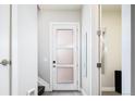 Bright entryway featuring tiled floors, stairs, and a frosted glass door leading to additional rooms at 1323 Elati St # 3, Denver, CO 80204