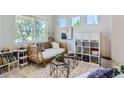 Bright room featuring a comfy daybed, decorative shelving, and stylish decor at 2312 Dogwood Dr, Erie, CO 80516