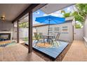 Inviting outdoor patio with seating, a blue umbrella, and decorative elements at 6515 Pinewood Dr, Parker, CO 80134