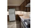 Efficient kitchen featuring ample cabinet space, tile backsplash, and modern appliances at 8542 W 10Th W Ave, Lakewood, CO 80215