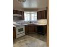 Functional kitchen featuring classic cabinetry, essential appliances, and a cozy breakfast nook at 8542 W 10Th W Ave, Lakewood, CO 80215