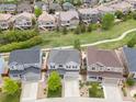 Aerial shot of a neighborhood showcasing well-maintained homes and green spaces; this home has a gray roof at 3319 Starry Night Loop, Castle Rock, CO 80109