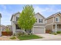 Beautifully landscaped front yard of this two-story home with a spacious two-car garage and welcoming porch at 3319 Starry Night Loop, Castle Rock, CO 80109