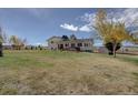 Expansive backyard featuring a screened-in porch with hot tub and ample space for outdoor activities at 11810 Mesa View Rd, Larkspur, CO 80118