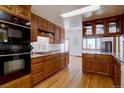 Bright kitchen with wooden cabinets, granite counters, tiled backsplash, and stainless steel appliances at 11810 Mesa View Rd, Larkspur, CO 80118